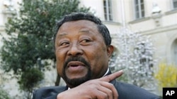 African Union Commission Chairman Jean Ping arrives to address media before making a statement on Libya to students, in Paris, March 24, 2011
