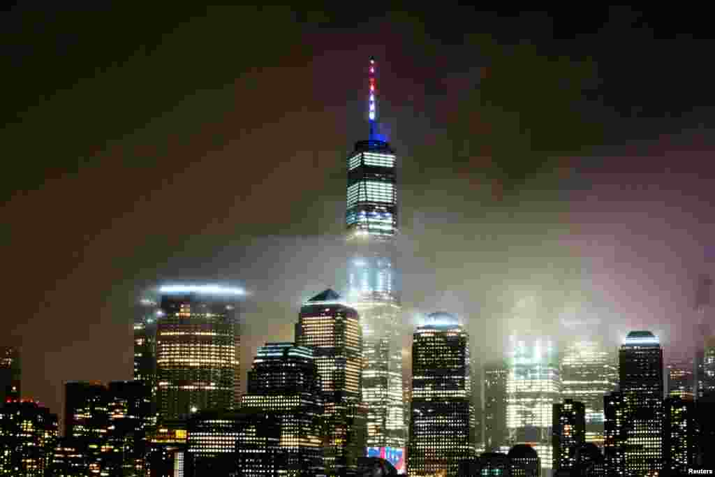 The One World Trade Center is illuminated in red, white and blue in recognition of the ongoing nationwide effort to combat the coronavirus outbreak in New York City, as it is seen from Exchange Place, New Jersey, March 30, 2020.