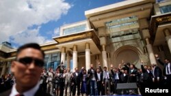 Mongolia's President Tsakhia Elbegdorj celebrates his re-election with members of his cabinet and party in front of the national parliament building in downtown Ulan Bator, June 27, 2013.