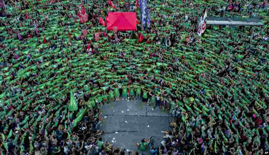 Pro-choice activists in favor of decriminalizing abortion raise green handkerchiefs as they demonstrate outside Congress in Buenos Aires, Argentina, February 19, 2019.