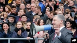 Ukrainian President Petro Poroshenko speaks to a crowd ahead of the presidential elections on upcoming April 21, at the Olympic stadium in Kyiv, April 14, 2019.