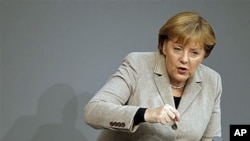 German Chancellor Angela Merkel gestures during her speech at the German federal parliament, the Bundestag, in Berlin, Germany, December 14, 2011.