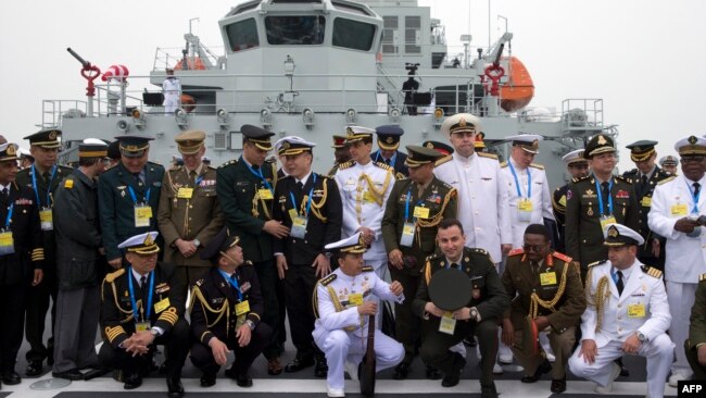 FILE - Foreign naval officers gather for a photo on the naval training ship Qi Jiguang before a parade to commemorate the 70th anniversary of the founding of China's PLA Navy April 23, 2019.