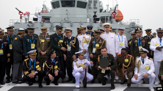 FILE - Foreign naval officers group up for a photo on the naval training ship Qi Jiguang before a celebration to remember the 70th anniversary of the founding of China's PLA Navy April 23, 2019. (Photo by Mark Schiefelbein / POOL / AFP)