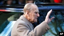 FILE - Britain's Prince Philip waves to the public as he leaves after attending a Christmas day church service in Sandringham, England, Dec. 25, 2016.