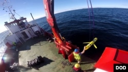 In this file photo, crew members aboard the VOS Raasay recover U.S. and British Royal Navy ocean gliders during an exercise off the northwest coast of Scotland, Oct. 8, 2016. U.S. defense officials say a similar unmanned vehicle was seized by the Chinese Navy in inter