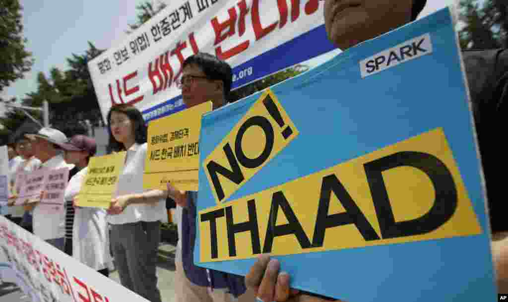 Protesters rally to denounce deploying the Terminal High-Altitude Area Defense, or THAAD, in front of the Defense Ministry in Seoul. U.S. and South Korean military officials say they&#39;re ready to deploy the advanced U.S. missile system in South Korea to cope with North Korean threats.