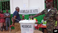 A Guinea-Bissau soldier cast's his ballot at a polling station in Bissau, Guinea-Bissau, May 18, 2014. 
