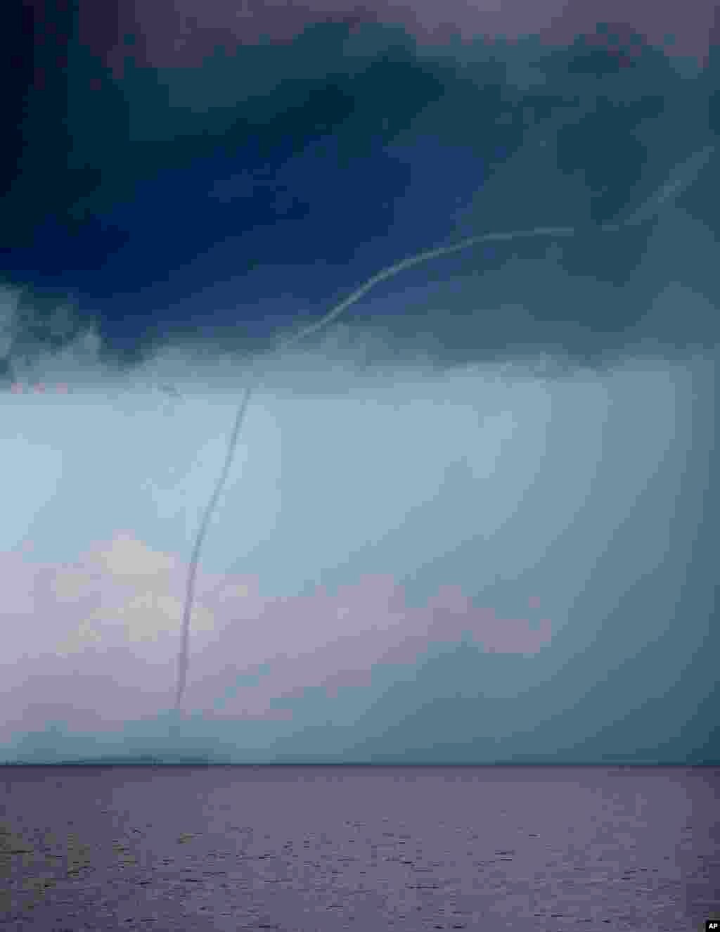 A waterspout dissipates on Lake Pontchartrain, as storm clouds enter the area in New Orleans, Louisiana, USA.