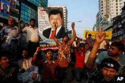FILE - Bangladeshi opposition activists shout slogans carrying a portrait of Elias Ali, an opposition politician who is suspected to have been abducted by security forces in Dhaka, May 9, 2012.