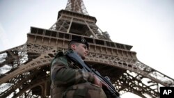 A French soldier stands guard under the Eiffel Tower in Paris, Nov. 1, 2017.