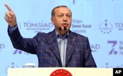 FILE - Turkey's President Recep Tayyip Erdogan, gestures as he delivers a speech at a conference in Istanbul, April 29, 2017.