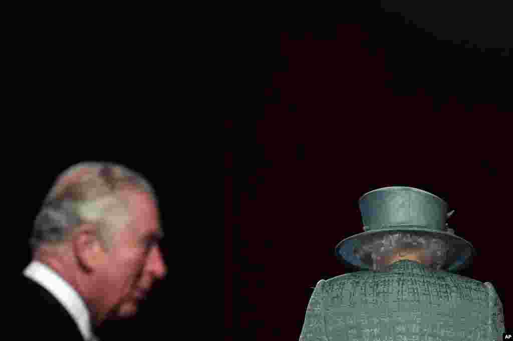 Britain&#39;s Queen Elizabeth and Prince Charles arrive for the State Opening of Parliament at the Houses of Parliament in London.