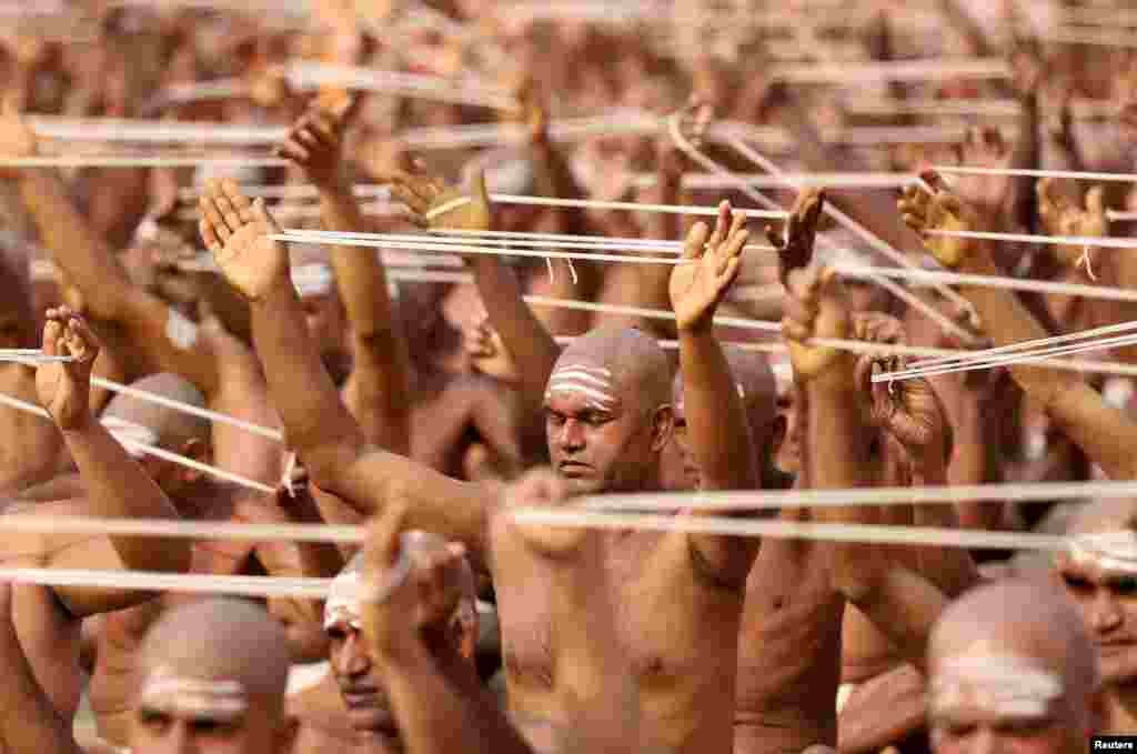Newly initiated Naga Sadhus or Hindu holy men of the Juna Akhara attend the Dikasha ritual on the banks of the river Ganges during the ongoing &quot;Kumbh Mela&quot;, or the Pitcher Festival, in Prayagraj, previously known as Allahabad, India.