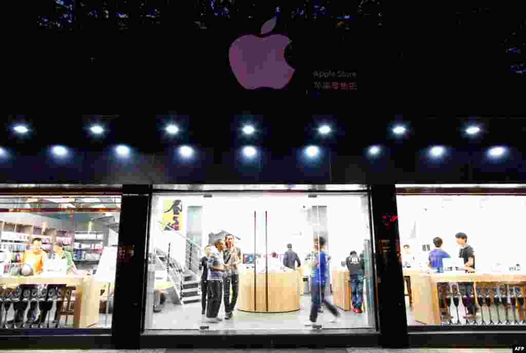 July 22: Customers and employees are seen from the exterior of a fake Apple Store in Kunming, Yunnan province. The fake Apple store, made famous by a blog that said even the staff working there didn't realise it was a bogus outlet, is seen as an example o