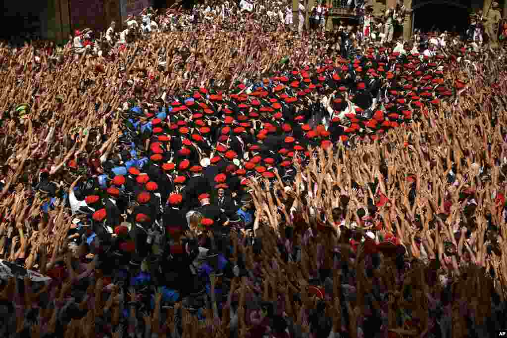 A municipal brass band makes it's away through a crowd of revellers during the launch of the 'Chupinazo' rocket, to celebrate the official opening of the 2018 San Fermin fiestas with daily bull runs, bullfights, music and dancing in Pamplona, Spain.