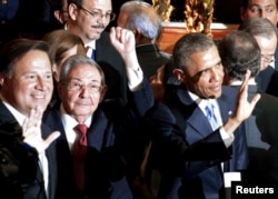 From left, leaders Juan Carlos Varela of Panama, Raul Castro of Cuba and Barack Obama of the United States acknowledge summit cameras in this handout photo, April 10, 2015.