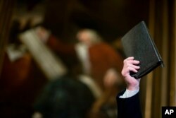 FILE - A man holds up a Bible at a rally in Atlanta, Ga., Jan. 13, 2015.