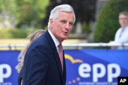FILE - The EU chief Brexit negotiator Michel Barnier arrives for a meeting in Brussels, June 22, 2017.