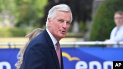 FILE - The EU chief Brexit negotiator Michel Barnier arrives for an EPP meeting in Brussels, June 22, 2017