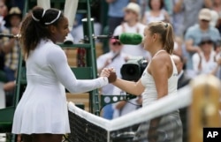 Serena Williams of the United States, left, shakes hands with Russia's Evgeniya Rodina after defeating her in their women's singles match, on day seven of the Wimbledon Tennis Championships, in London, Monday July 9, 2018. (AP Photo/Tim Ireland)