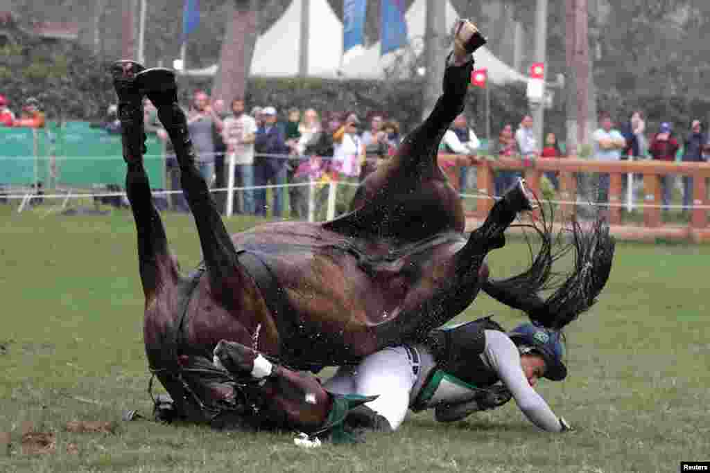 Brazil&#39;s Ruy Leme Da Fonseca Fil riding Ballypatrick SRS falls after a jump in the eventing&#39;s individual cross country of the equestrian competition during the XVIII Pan American Games in Lima, Peru, Aug. 3, 2019.