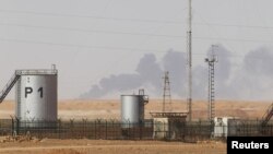 Smoke rises above following demining operations at the In Amenas gas plant, January 20, 2013.