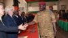 Lieutenant Colonel Isaac Zida, named by Burkina Faso's army as interim leader following the ousting of president Blaise Compaore,shakes hands with ambassadors during a meeting gathering soldiers and diplomats on Nov. 3, 2014 in Ouagadougou. 