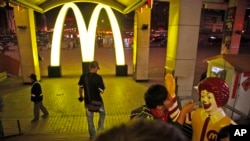 A Chinese man takes a photo with Ronald McDonald at a McDonald's fast food restaurant in China's northern Liaoning province. (2011 File Photo) 