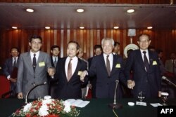 FILE: The leaders of the Cambodian factions join hands at a press conference at the end of their talks where the reached a peace agreement to end the Cambodian war on September 10, 1990 at Jakarta. (From L) Cambodian Prime Mininster Hun Sen, the law academic Norodom Ranariddh, Red Khmer's leader Khieu Samphan and anti-communist FLNPK leader Son Sann.