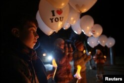 Children carry balloons before releasing them toward Damascus city, on the first day of the truce, to send a message that civil activity will continue in the rebel-held Jobar, a suburb of Damascus, Syria, Dec. 30, 2016.