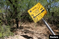 A warning sign written in Spanish reads "Watch out! Do not expose your life to the elements. It's not worth it! No drinking water" on the U.S.-Mexico border on the Tohono O'odham reservation in Chukut Kuk, Arizona, April 6, 2017.