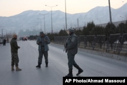 Afghan security forces stand guard near the site of two blasts in Kabul, Afghanistan, Jan. 10, 2017.