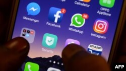 FILES - This March 22, 2018, photo shows apps for WhatsApp, Facebook, Instagram and other social networks on a smartphone in Chennai, India.