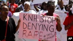 Protesters march along the streets of Nairobi holding placards against the rape allegation by staff of Kenyatta National Hospital in Nairobi, Kenya, Jan. 23, 2018. 