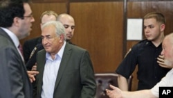 Former IMF chief Dominique Strauss-Kahn stands to depart his bail hearing inside of the New York State Supreme Courthouse in New York . Strauss-Kahn was granted bail by a New York judge, May 19, 2011
