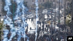 Israeli troops fire teargas towards Palestinians during a protest against U.S. President Donald Trump's decision to recognize Jerusalem as the capital of Israel in the West Bank city of Bethlehem, Dec. 7, 2017.