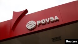 FILE - The corporate logo of the state oil company PDVSA is seen at a gas station in Caracas, Venezuela, March 22, 2017. 