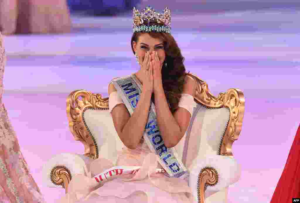 Miss South Africa and the 2014 Miss World, Rolene Strauss, reacts after being crowned during the grand final of the Miss World 2014 pageant at the Excel London ICC Auditorium in London.