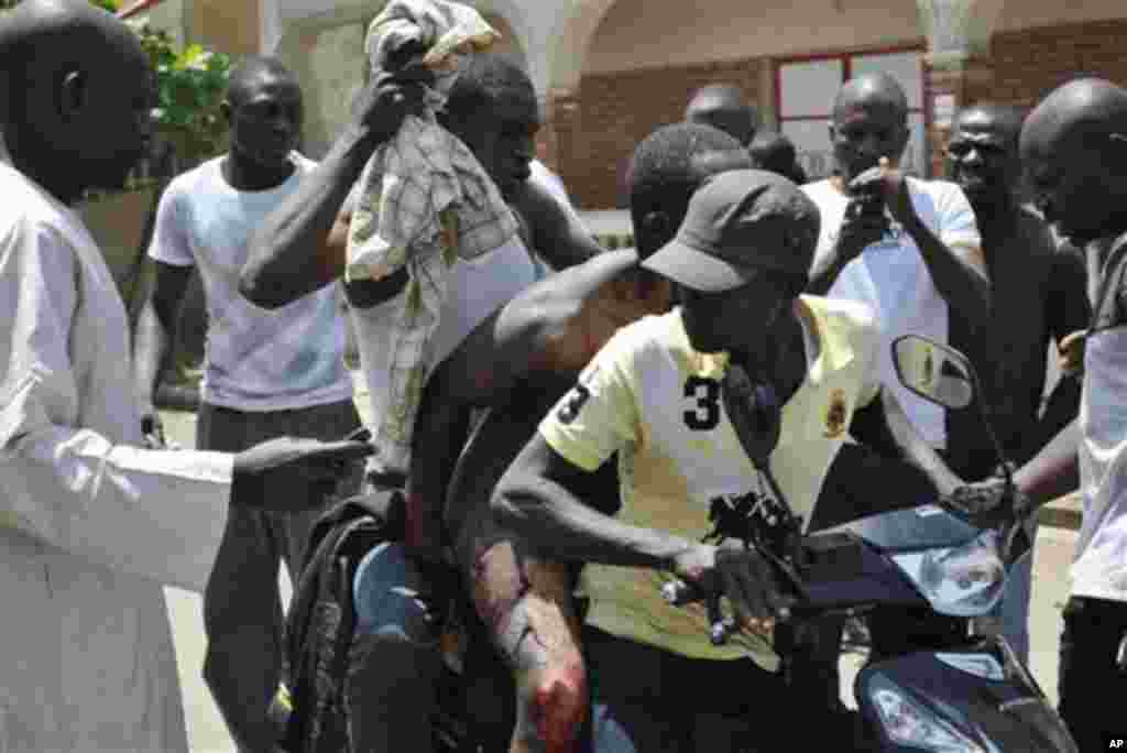 An Injured man is been transported on a motor taxi following a bomb explosion in Kaduna, Nigeria, Thursday, April. 26, 2012.