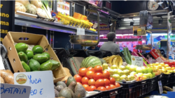 Ana Galiardi tiene una frutería, donde, además de productos originarias de Europa, vende de su país natal, como la yuca. Foto: VOA.