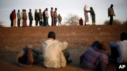 Travelers driving from Niamey, Niger, lining up to be searched at the entrance of Gao, northern Mali, Feb. 12, 2013.
