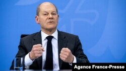 FILE - German Chancellor Olaf Scholz gestures as he speaks at a press conference at the Chancellery in Berlin, Dec. 21, 2021.