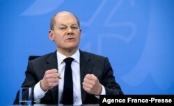 FILE - German Chancellor Olaf Scholz gestures as he speaks at a press conference at the Chancellery in Berlin, Dec. 21, 2021.
