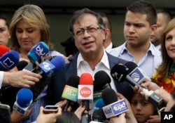 FILE - Gustavo Petro, presidential candidate for Colombia Humana, talks with the press after casting his ballot during the presidential election in Bogota, Colombia, June 17, 2018.