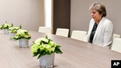 British Prime Minister Theresa May waits for the arrival of European Council President Donald Tusk before a bilateral meeting during an EU summit in Brussels, Oct. 20, 2017. European Union leaders gathered Friday to weigh progress in negotiations on Britain's departure.