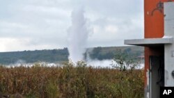 A geyser of gasoline spews from a state-owned pipeline at a field in Tlajomulco, Mexico, Oct. 30, 2013.