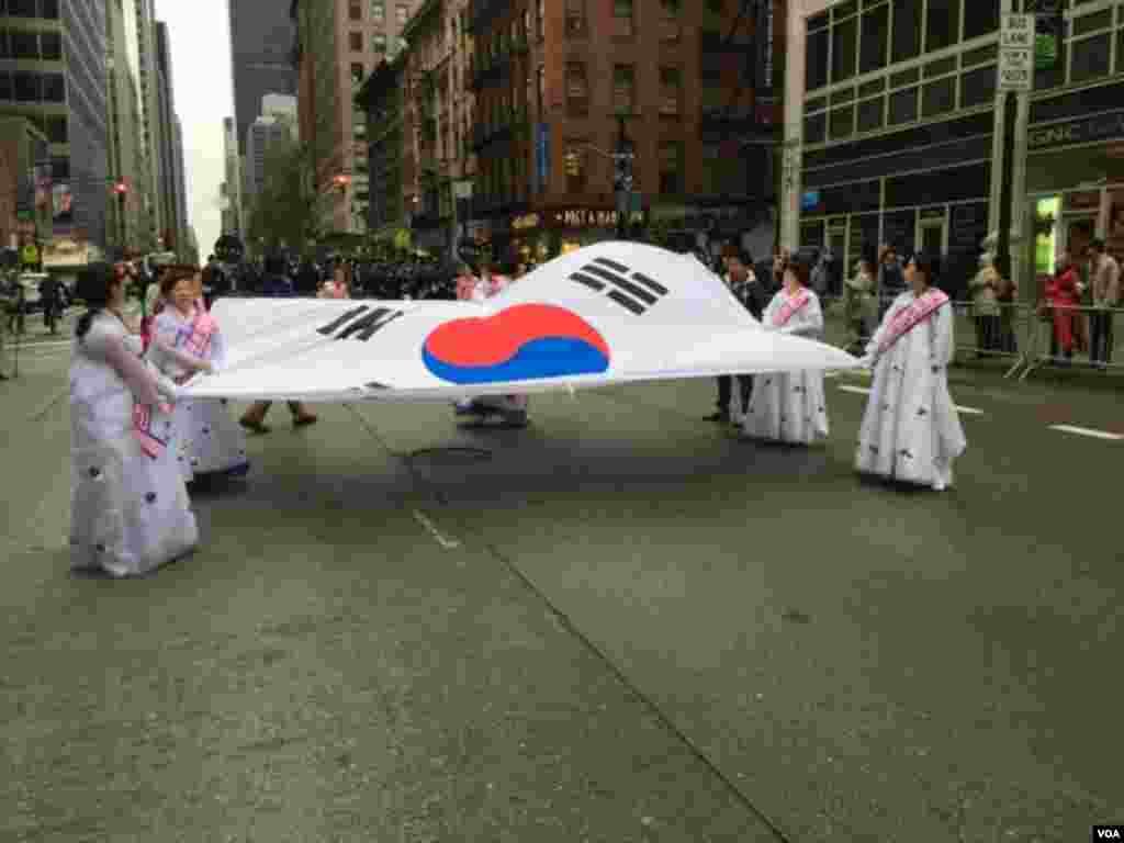 کوریائی ڈے پریڈ میں شرکا جنوبی کوریا کے جھنڈے کے ہمراہ