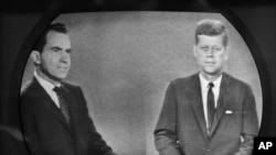 Vice President Richard M. Nixon (l) listens as Senator John F. Kennedy talks during their televised presidential race debate,Oct. 21, 1960. 