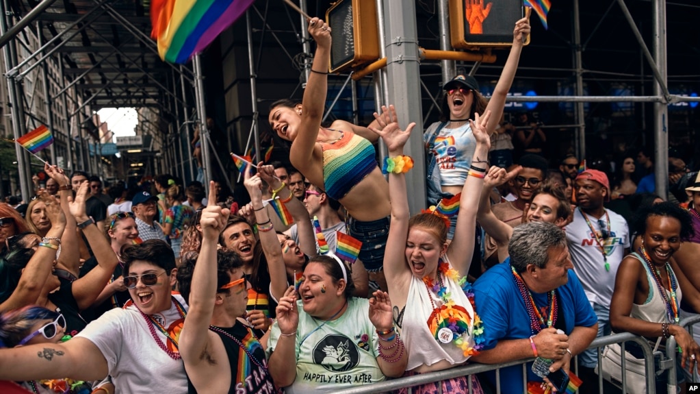People cheer as floats travel along Fifth Avenue during the New York City Pride Parade, June 25, 2017.